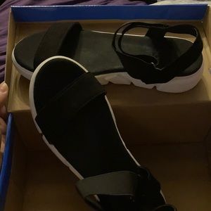 Black and white sandals with a suede type fabric